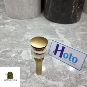 Đầu xả lavabo bằng đồng màu vàng cổ.